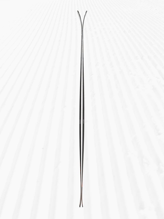 Side profile of 2025 Armada Declivity 88C skis on groomed snow, showing the camber and rocker shape.