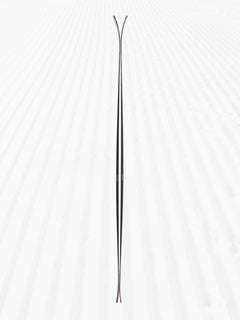 Side profile of 2025 Armada Declivity 88C skis on groomed snow, showing the camber and rocker shape.